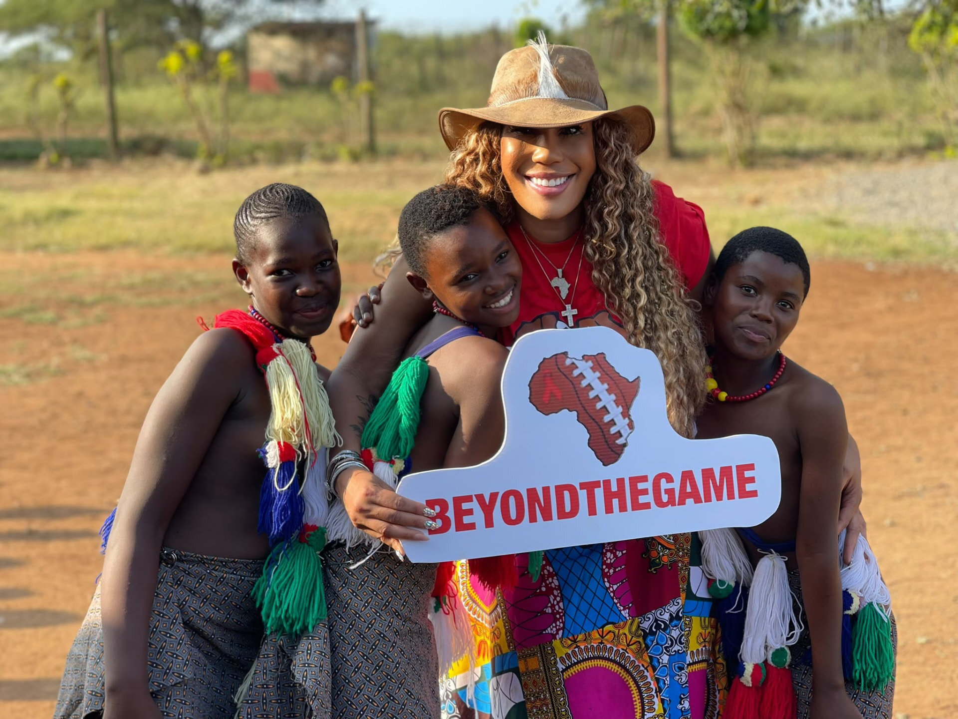 Children holding a Beyond The Game sign