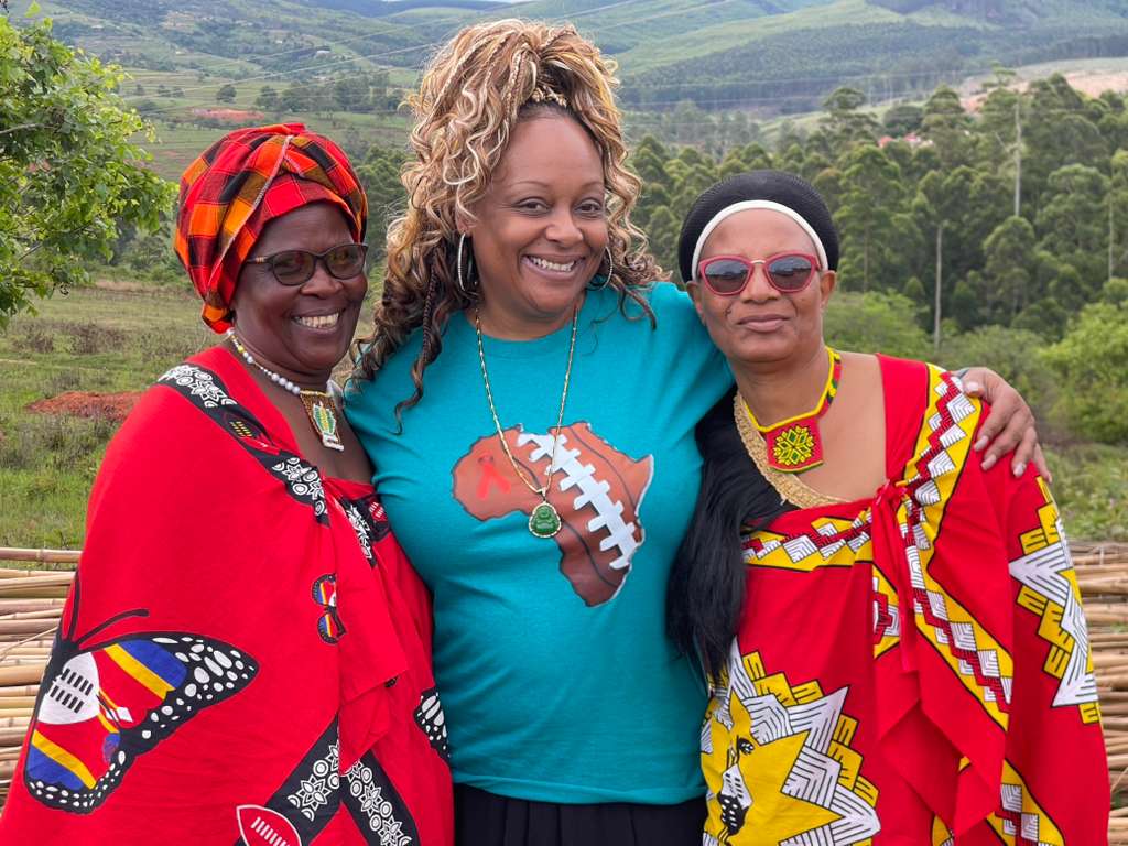 Dr Chanita Foster with two Eswatini elders in traditional emahiya dress